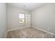 Charming bedroom with built-in shelving and a window at 1907 Catkin Ln, Charlotte, NC 28205