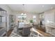 Modern dining area with wooden table, gray chairs, and large windows at 1907 Catkin Ln, Charlotte, NC 28205