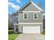 Two-story house, gray siding, white garage door, and a neat lawn at 3008 Sadler Woods Ln, Charlotte, NC 28214