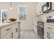 White kitchen with stainless steel appliances and an island at 3008 Sadler Woods Ln, Charlotte, NC 28214