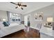 Cozy bedroom with hardwood floors, large windows, and ceiling fan at 301 W 10Th St # 205, Charlotte, NC 28202