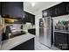 Updated kitchen with dark cabinetry and stainless steel appliances at 301 W 10Th St # 205, Charlotte, NC 28202