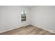 Small bedroom with wood floors and a window at 3016 Sadler Woods Ln, Charlotte, NC 28214