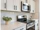 Kitchen with white cabinets, quartz countertops, and stainless steel range at 3016 Sadler Woods Ln, Charlotte, NC 28214