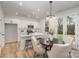 Modern white kitchen with stainless steel appliances and an island at 3016 Sadler Woods Ln, Charlotte, NC 28214