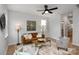 Living room with hardwood floors, a brown leather couch, and two armchairs at 3016 Sadler Woods Ln, Charlotte, NC 28214