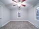 Spacious bedroom featuring a ceiling fan and large windows at 315 W Clairmont St, Troy, NC 27371