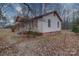 View of house exterior with yard and surrounding trees at 315 W Clairmont St, Troy, NC 27371