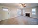 Living room with fireplace and neutral carpeting at 315 W Clairmont St, Troy, NC 27371