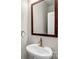 Simple bathroom with pedestal sink and wood framed mirror at 3323 Glenn Hope Way, Matthews, NC 28104