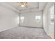 Bright bedroom with ceiling fan, carpet, and two windows at 3323 Glenn Hope Way, Matthews, NC 28104