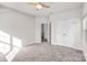 Bedroom with carpet, ceiling fan and access to another room at 3323 Glenn Hope Way, Matthews, NC 28104