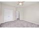 Bedroom with ceiling fan, carpet, and double doors to closet at 3323 Glenn Hope Way, Matthews, NC 28104