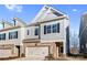 Two-story townhome with gray siding, brick accents, and a two-car garage at 3323 Glenn Hope Way, Matthews, NC 28104