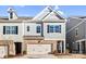 Two-story townhome with gray siding, brick accents, and a two-car garage at 3323 Glenn Hope Way, Matthews, NC 28104