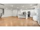 Modern kitchen with island, stainless steel appliances, and hardwood floors at 3323 Glenn Hope Way, Matthews, NC 28104