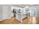 Modern kitchen with island, stainless steel appliances, and hardwood floors at 3323 Glenn Hope Way, Matthews, NC 28104