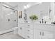 This bathroom has double sinks, white cabinets and an open glass shower at 3705 Lou Ann Ave, Charlotte, NC 28208