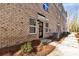 Beautiful brick townhome entrance featuring a modern door and well-kept landscaping at 3705 Lou Ann Ave, Charlotte, NC 28208