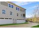 Side view of three-story townhome, showcasing attached garage and landscaping at 3705 Lou Ann Ave, Charlotte, NC 28208