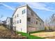 Corner view of three-story townhome showcasing attached garage and landscaping at 3705 Lou Ann Ave, Charlotte, NC 28208