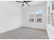 Bright, vacant bedroom with a ceiling fan, carpet, and a large window providing natural light at 3709 Lou Ann Ave, Charlotte, NC 28208