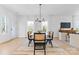 Dining room with glass top table, cane back chairs, and decorative chandelier at 3709 Lou Ann Ave, Charlotte, NC 28208