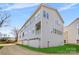 Side view of three-story townhome with attached garages and a small lawn at 3709 Lou Ann Ave, Charlotte, NC 28208