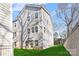 Three-story townhome building with light gray siding and a green lawn at 3709 Lou Ann Ave, Charlotte, NC 28208