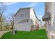 Rear view of townhome with a grassy area and AC unit at 3709 Lou Ann Ave, Charlotte, NC 28208