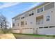 Rear view of three-story townhome with attached garages and balconies at 3709 Lou Ann Ave, Charlotte, NC 28208