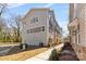 Exterior view of a townhouse showcasing siding and brick details, manicured landscaping, and a welcoming entrance at 3709 Lou Ann Ave, Charlotte, NC 28208