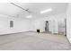 Large garage with concrete flooring and a storage room with a water heater at 3709 Lou Ann Ave, Charlotte, NC 28208