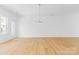 Spacious living room featuring wood floors, a modern chandelier, ample natural light, and an open-concept design at 3709 Lou Ann Ave, Charlotte, NC 28208