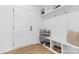 Mudroom area with hooks, storage bench, baskets, and neutral colored pillows at 3709 Lou Ann Ave, Charlotte, NC 28208