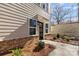 New townhouse entrance featuring a modern front door, landscaped yard, and exterior lighting at 3713 Lou Ann Ave, Charlotte, NC 28208