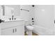 Clean bathroom featuring vanity, white tile, tub, and modern fixtures at 3717 Lou Ann Ave, Charlotte, NC 28208