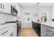 Beautiful kitchen featuring white countertops, dark cabinetry, stainless steel appliances, and ample lighting at 3717 Lou Ann Ave, Charlotte, NC 28208