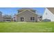 Gray house back with sliding glass door, window, and AC unit, all overlooking a grassy backyard at 4540 Dusty Orchard Rd, Kannapolis, NC 28081