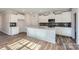 Modern kitchen with white cabinets, island, and gray backsplash at 4540 Dusty Orchard Rd, Kannapolis, NC 28081