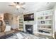 Living room fireplace with built-in shelving and hardwood floors at 5158 Turtle Creek Dr, Denver, NC 28037