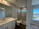 Modern bathroom featuring a tiled shower with glass door, white vanity, and updated fixtures at 5552 Stafford Rd # 28, Charlotte, NC 28215