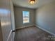 Cozy bedroom with neutral walls and carpet, offering a comfortable and simple design at 5552 Stafford Rd # 28, Charlotte, NC 28215