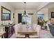 Dining room with large wooden table and six chairs, leading to living room at 612 Spencer Ln, Kannapolis, NC 28081