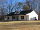 White house with black roof and trim, covered front porch, and large backyard at 6524 Athens Ln, York, SC 29745