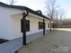 White house with black roof and trim, covered front porch, and large backyard at 6524 Athens Ln, York, SC 29745