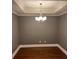 Dining room featuring hardwood floors, crown molding, and a modern chandelier at 6605 Central Pacific Ave, Charlotte, NC 28210