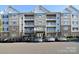 Multi-story condo building with gray and stone facade and ample parking at 6605 Central Pacific Ave, Charlotte, NC 28210