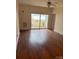 Living room featuring hardwood floors, a sliding glass door to balcony, and a ceiling fan at 6605 Central Pacific Ave, Charlotte, NC 28210