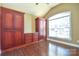 Spacious bedroom with hardwood floors and built-in wooden cabinets at 7757 St Andrews Ln, Stanley, NC 28164